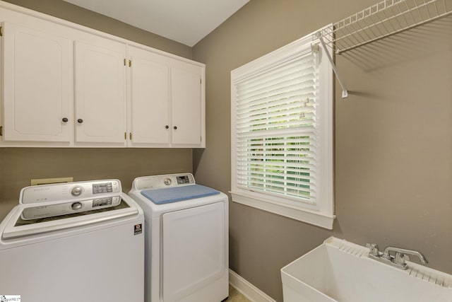 laundry area featuring cabinets, sink, and washing machine and dryer