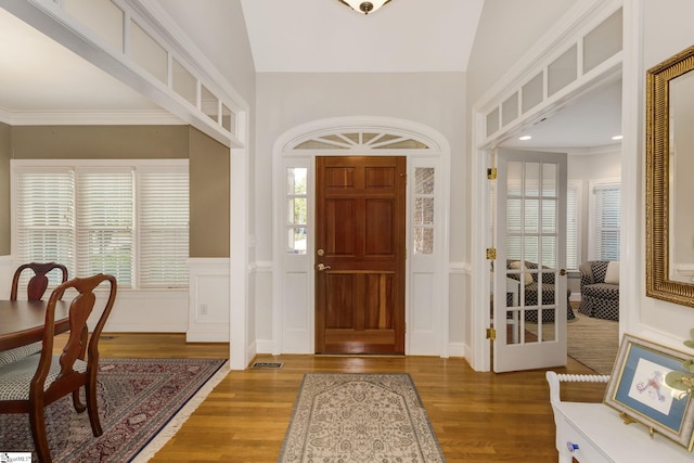 foyer entrance featuring a wealth of natural light, hardwood / wood-style flooring, and lofted ceiling