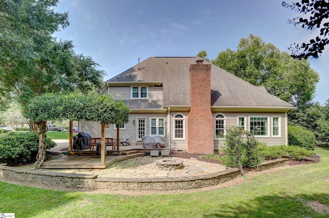 back of house with a patio area, a lawn, and a wooden deck