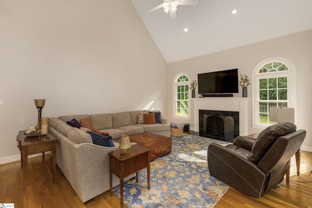 living room with light wood-type flooring, a wealth of natural light, and ceiling fan