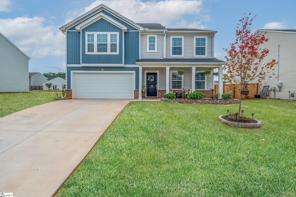 craftsman-style house featuring a garage, a front lawn, and a porch