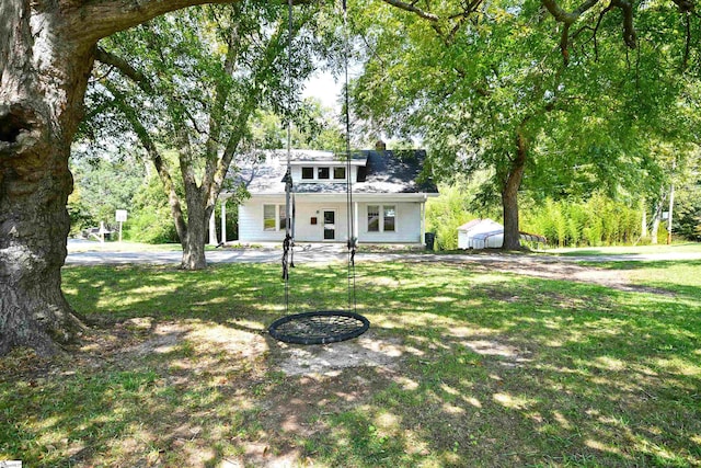 view of front facade with a patio and a front yard