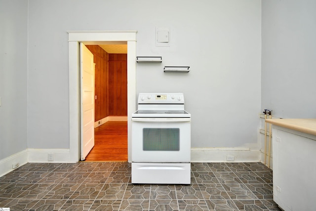 kitchen featuring dark wood-type flooring and electric stove