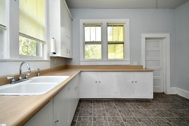 kitchen with sink and white cabinetry