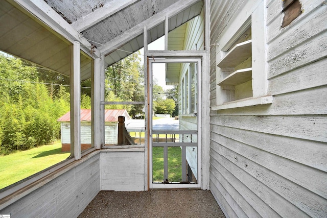 unfurnished sunroom with lofted ceiling