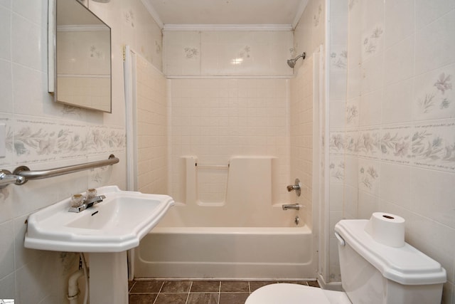 bathroom with tile walls, toilet, bathing tub / shower combination, and ornamental molding