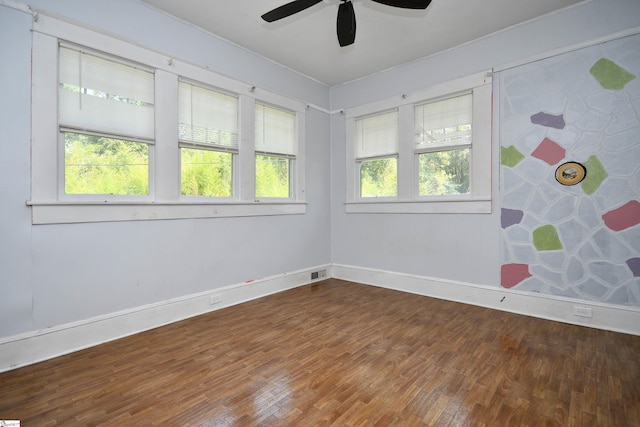 empty room with ceiling fan and wood-type flooring