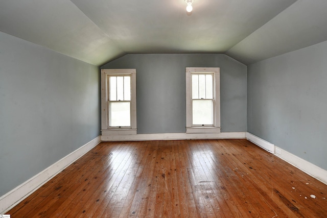 bonus room featuring a baseboard radiator, vaulted ceiling, and hardwood / wood-style flooring