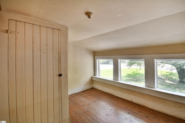 unfurnished room with wood-type flooring