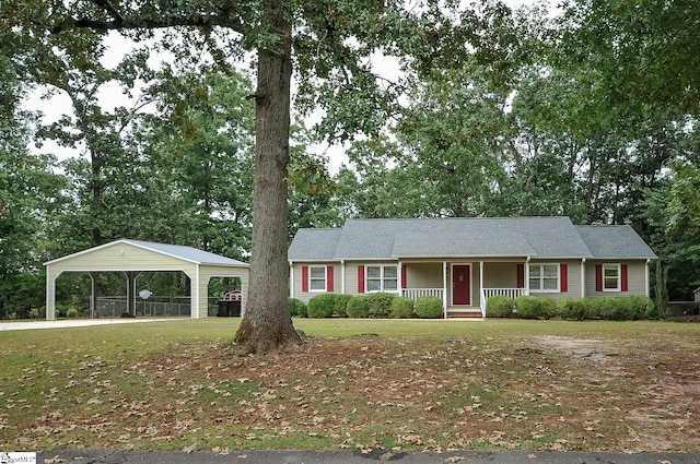 ranch-style home featuring covered porch, a carport, and a front lawn