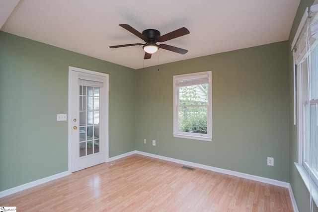 empty room featuring ceiling fan and light hardwood / wood-style floors