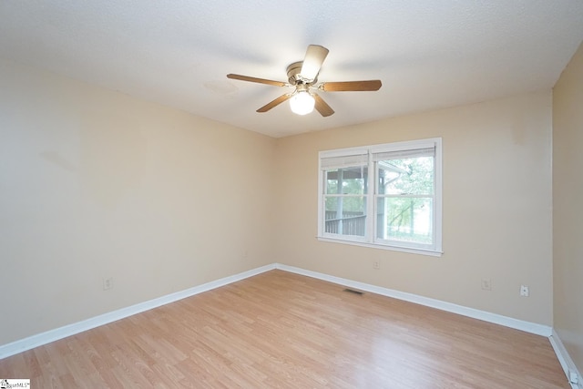 unfurnished room with light hardwood / wood-style flooring and ceiling fan