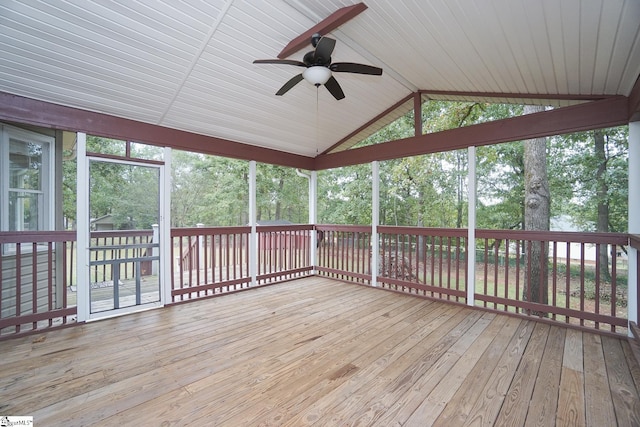 unfurnished sunroom with ceiling fan and vaulted ceiling