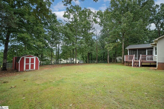 view of yard featuring a shed and a deck