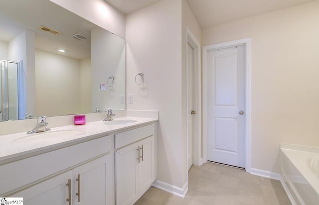 bathroom featuring a sink, baseboards, and visible vents
