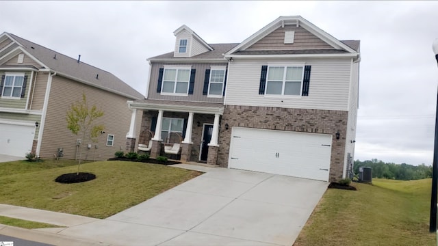 craftsman house with a front lawn and a garage