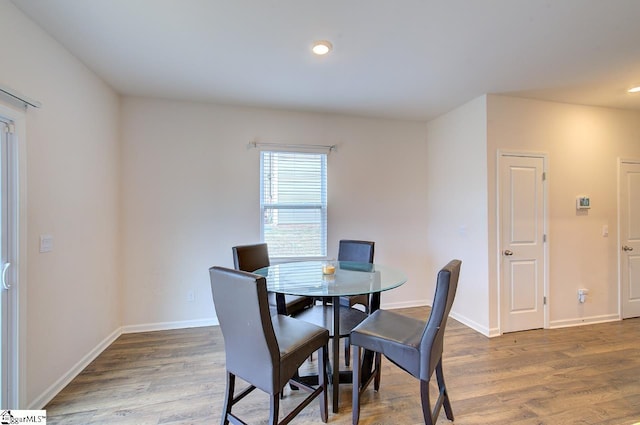 dining space featuring baseboards, recessed lighting, and wood finished floors