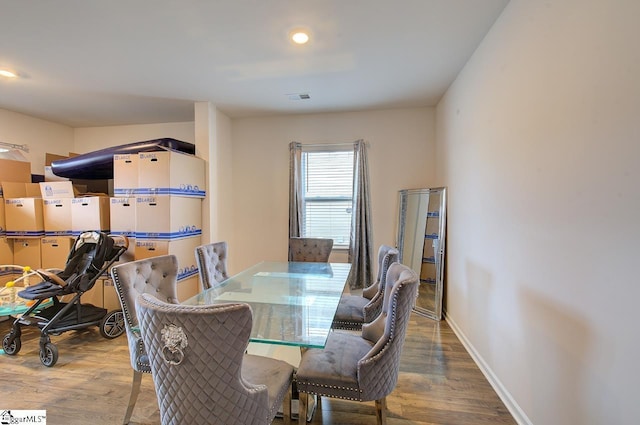 dining room with visible vents, recessed lighting, baseboards, and wood finished floors