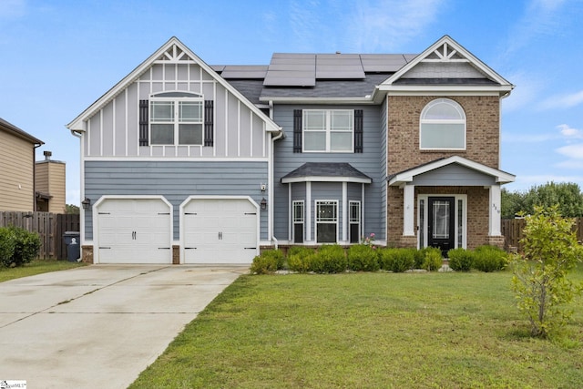 view of front of property with a garage, a front lawn, and solar panels