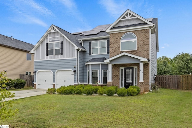 craftsman inspired home featuring a garage, a front lawn, and solar panels