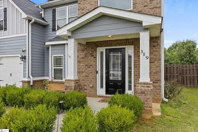 doorway to property with a garage