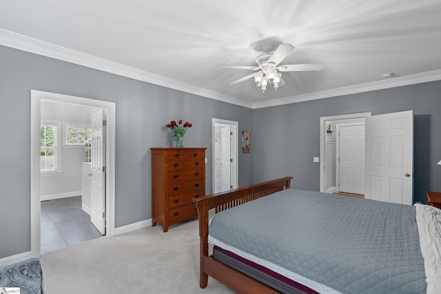 bedroom with ceiling fan, light colored carpet, connected bathroom, and crown molding