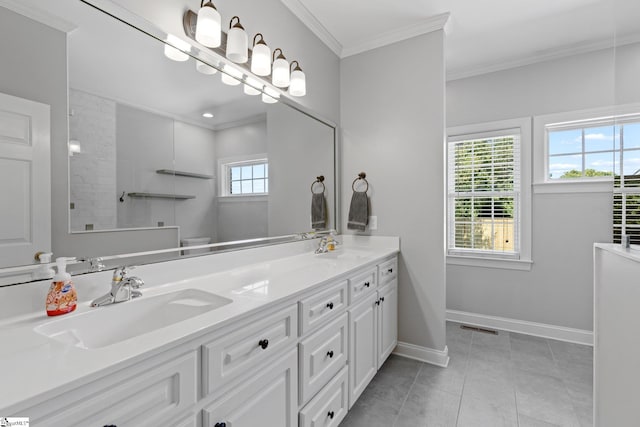 bathroom with tile patterned floors, ornamental molding, and vanity