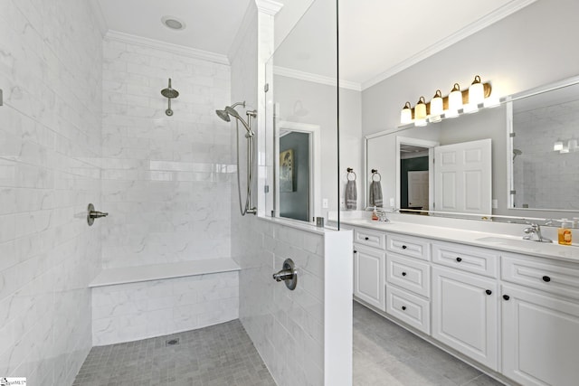 bathroom featuring vanity, ornamental molding, and a tile shower