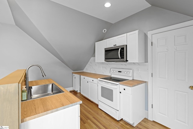 kitchen with vaulted ceiling, white electric range oven, white cabinetry, and light hardwood / wood-style floors