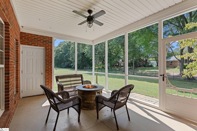 sunroom / solarium featuring a wealth of natural light and ceiling fan