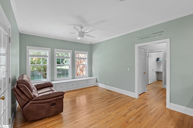 sitting room with ornamental molding, light hardwood / wood-style flooring, and ceiling fan