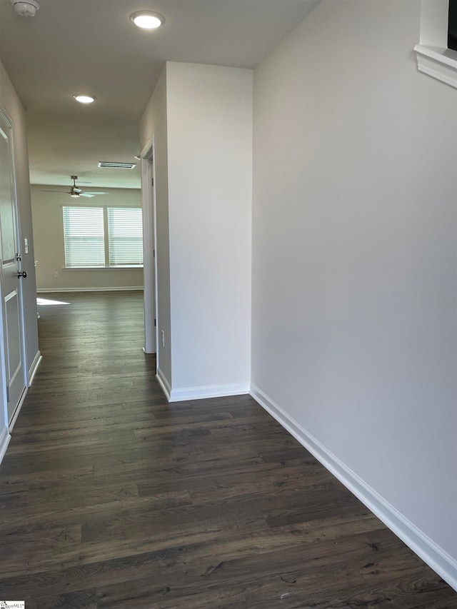 hallway with dark hardwood / wood-style floors