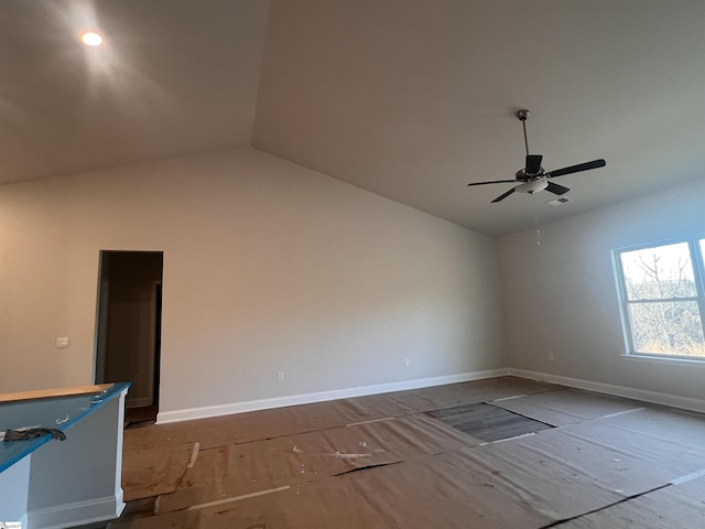 empty room featuring ceiling fan and vaulted ceiling