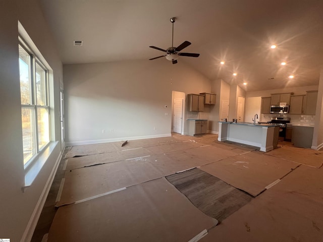 unfurnished living room featuring high vaulted ceiling, ceiling fan, and sink