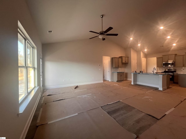 unfurnished living room featuring high vaulted ceiling, ceiling fan, and sink