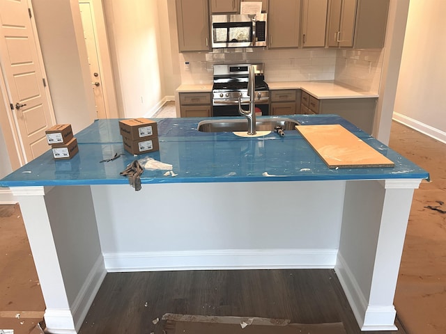 kitchen featuring sink, gray cabinets, backsplash, and appliances with stainless steel finishes