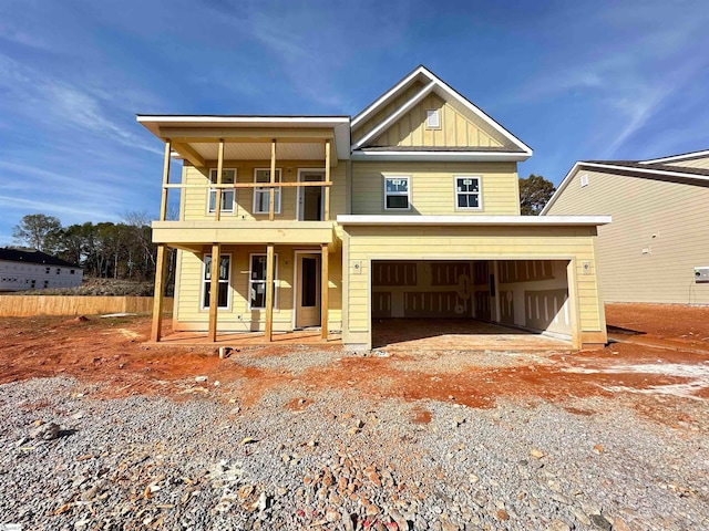 view of front of property with covered porch, a balcony, and a garage