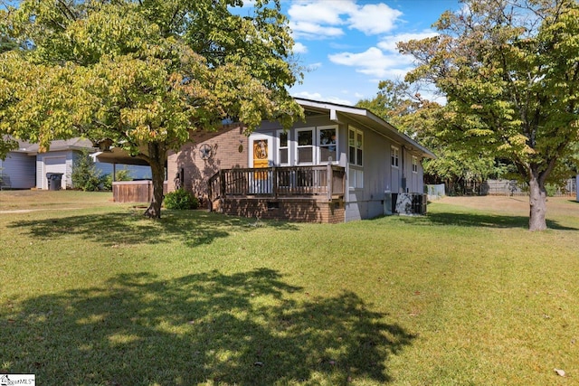 exterior space featuring a lawn and a deck