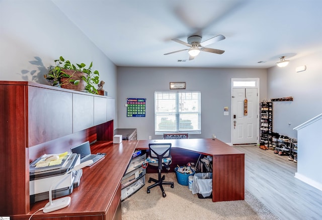 home office with light hardwood / wood-style flooring and ceiling fan