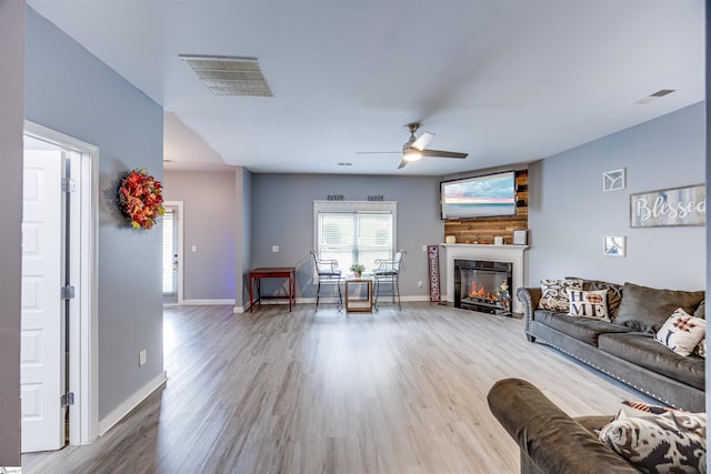 unfurnished living room featuring hardwood / wood-style flooring and ceiling fan