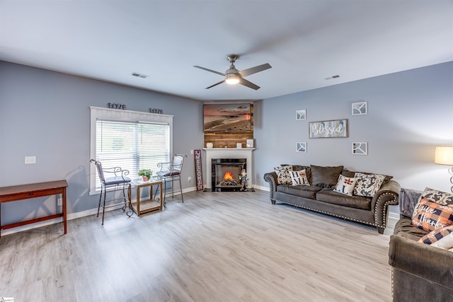 living room featuring light wood-type flooring and ceiling fan