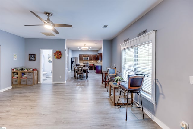 sitting room featuring light wood-type flooring and ceiling fan