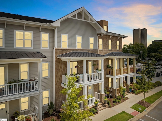 view of front of house featuring a balcony