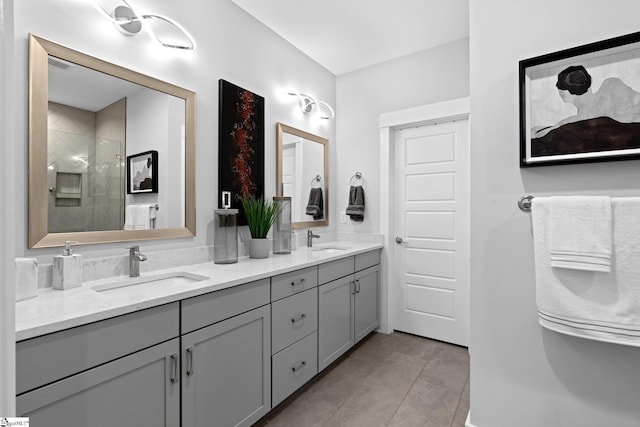 bathroom with tile patterned floors, a shower with shower door, and vanity