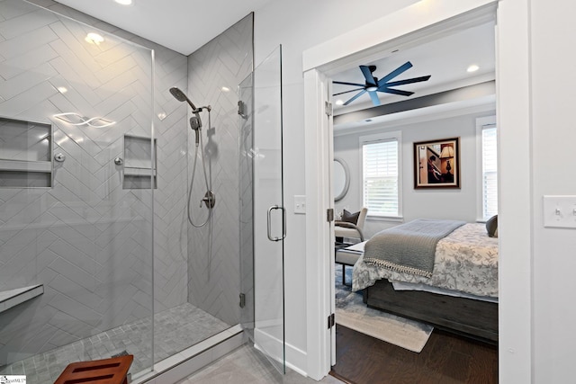 bathroom featuring a shower with shower door, ceiling fan, and hardwood / wood-style floors