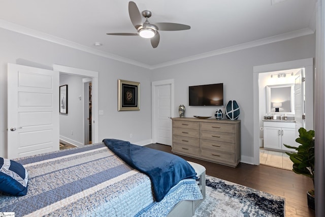 bedroom featuring ensuite bath, crown molding, dark hardwood / wood-style flooring, and ceiling fan