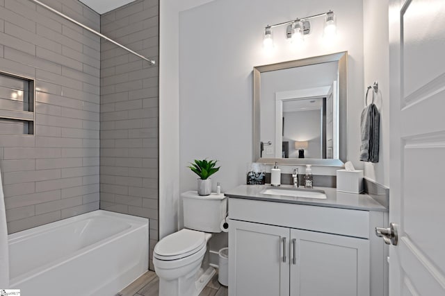 full bathroom with toilet, tiled shower / bath combo, and vanity