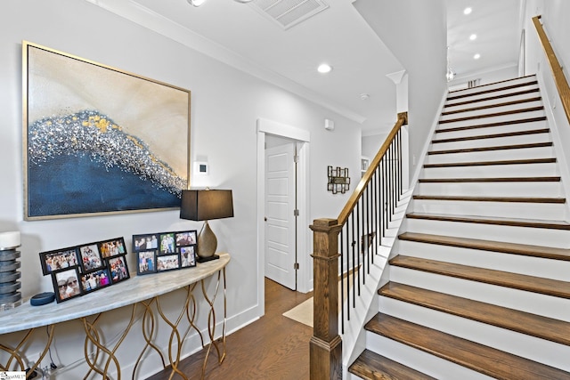 stairway featuring hardwood / wood-style floors and ornamental molding