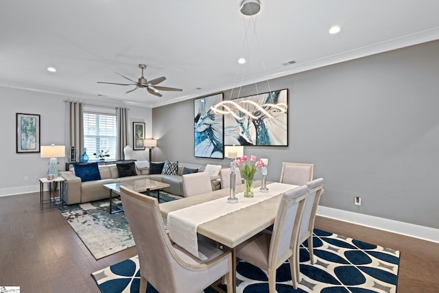 dining space with ornamental molding, ceiling fan, and dark hardwood / wood-style floors