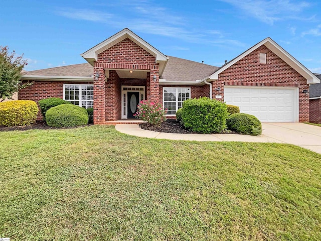 view of front of home with a front lawn and a garage